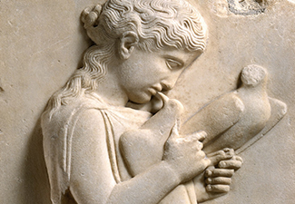 Ancient marble grave stele of a little girl and pet doves