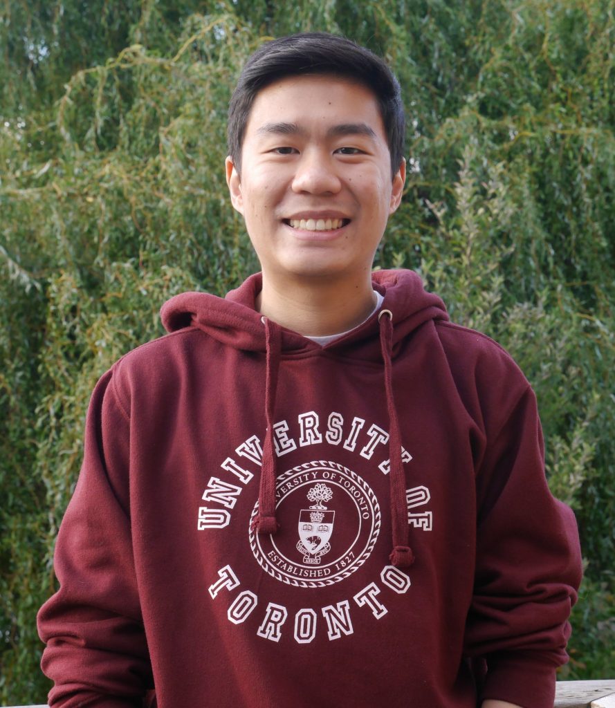 Headshot of Alex, he's wearing a hoodie that has the university's logo and name.