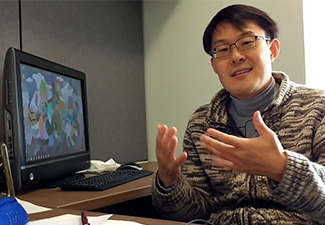 Chunghyoung Lee explaining in front of a computer screen