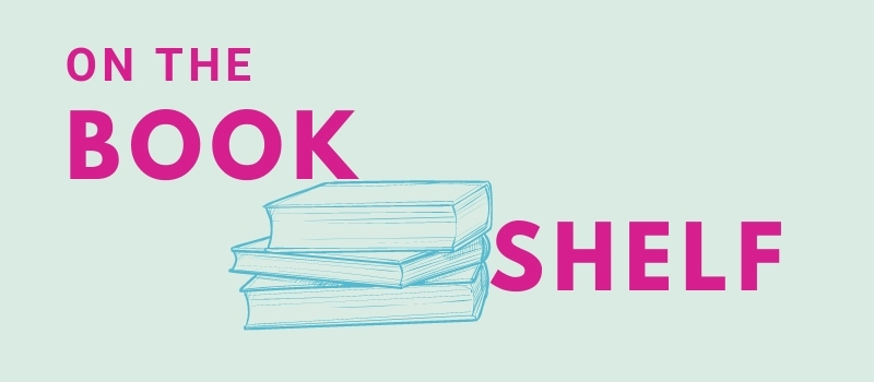 An illustration of a stack of books on a mint green background with the ords "On the Bookshelf" in fuchsia