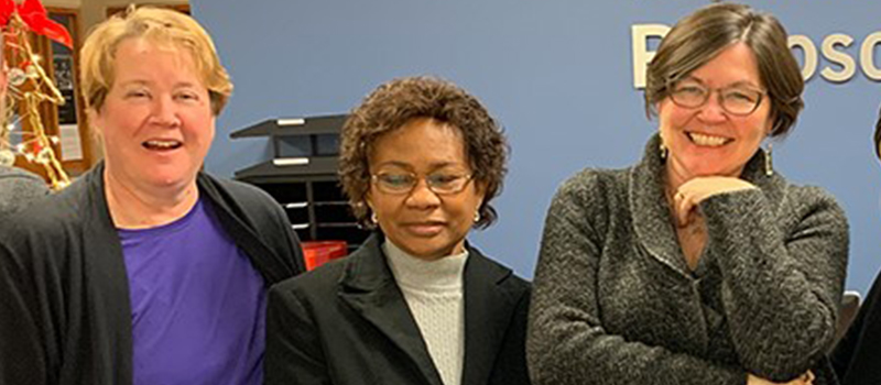 From left to right: Mary Frances Ellison, Margaret-Opoku-Pare, and Joanne Hurley smiling in the offices of the Department of Philosophy