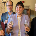 From left to right: Marleen Rozemond, Martin Pickavé, Michaela Manson, and Donald Ainslie smiling broadly and holding champagne glasses in a restaurant