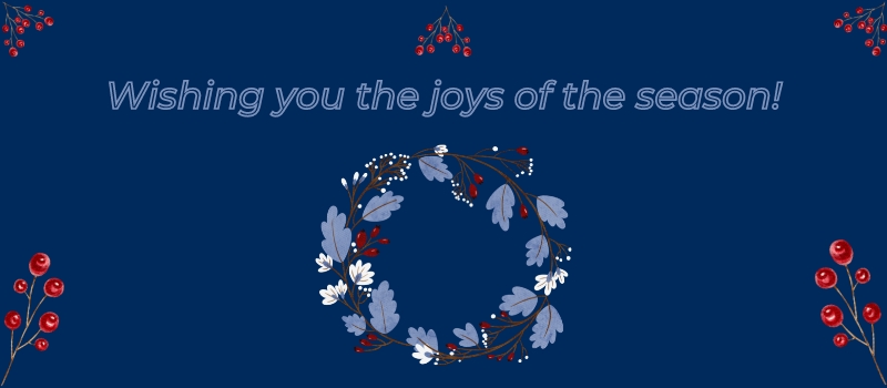 Wishing you the joys of the season, on U of T blue background with a red berry and blue leaf wreath
