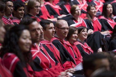 PhD students from a variety of graduate programs listen attentively during their Convocation ceremony.