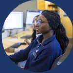 Woman seated in front of bank of computer screens. Text in blue background on left states Fans and Critics Welcome. Text on right states UTM certificate aims to equip students for age of AI