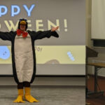 Two images of Donald Ainslie teaching, the one to the left in a full-length penguin costume, the one to the right as a UNICEF aid delivery box