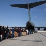 Afghanis lining up to board a U.S. military plane