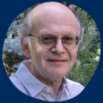 A balding older whit man with glasses and wearing a pin-striped button-down shirt standing in front of a backdrop of firs and lavender. The surrounding frame is U of T blue, with the name "Willi Goetschel" written in lilac.