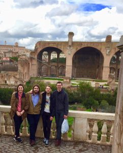 Four graduate students in front of the Roman Forum