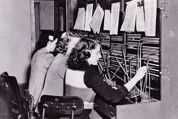 1950s telephone operators sitting at a switchboard